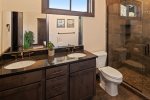Master bathroom with dual sinks and large walk-in shower
