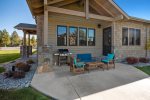 Private covered patio with furniture and Weber natural gas barbeque