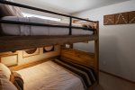 Queen sized bunk beds with convenient reading lights and charging areas.
