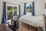 Second bedroom on main floor has a Queen bed, desk and deck access. 