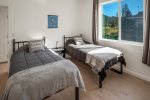 Third bedroom on main floor with twin beds. 