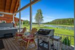Great patio setup with BBQ, hot tub, and river views