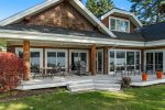 View of the back deck with ample outdoor furniture and BBQ.