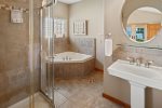Soaking tub and shower in guest house. 