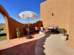 Entertaining patio with gas barbecue, sitting area with firepit, and dining table off the kitchen