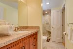 Guest bathroom has stand- up shower and granite counter top