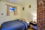 Back bedroom with full size futon and preserved 1921 chimney