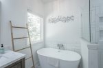 master bathroom - soak tub and large glass tiled shower