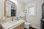 Full bathroom with laundry machines and gorgeous standing tile shower