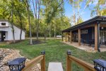 Small bridge over water facing the two tiny homes on the property