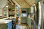 SAGE-TONED CUSTOM CABINETRY & POLISHED STONE COUNTERTOPS