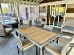 Cozy, Furnished screen porch with views of the pool area and acreage 