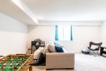 Basement features tons of room for kids to play and a custom neon sign