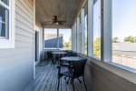 The screen porch off the back of the home has dining space