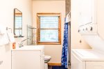 Downstairs bathroom with stackable washer and dryer