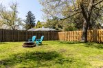 Grassy backyard with grill and fire pit