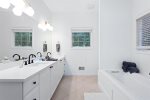 Stunning primary suite with deep soaker tub and custom tile shower