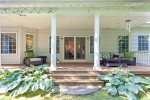 Inviting back porch space with cozy seating