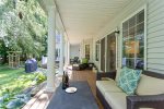 Inviting back porch space with cozy seating