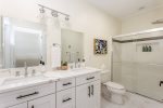 Large full bathroom off the game room with dual vanities 