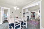 Kitchen flows into this dining area with seating area off to the side