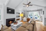 Lovely main floor living area with TV, seating and a beautiful window seat