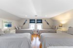 This upstairs bedroom sleeps a group with four twin beds