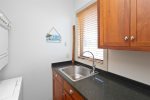 Convenient laundry access off the kitchen with wash sink