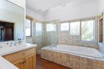 Soak in the large tub in the primary suite bathroom