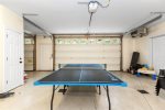 The garage features a fun ping pong table, providing entertainment and a great space for indoor recreation.