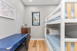 Charming main floor bedroom with bunks and a trundle bed