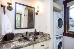 The main floor bathroom has a custom tile shower and access to the home`s laundry machines.