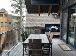 The home`s patio offers a grill, dining area, private hot tub, and slopeside views.