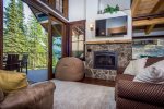 The stunning lofted ceiling and custom architecture beautifully frame the living space. 