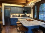 Enjoy a meal before you hit the slopes at the home`s expansive kitchen island and dining area.