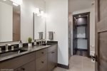 Offering a double vanity, custom tile shower, and heated floors, the primary ensuite is a spa-like retreat.