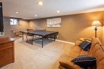 Game room down stairs with Ping Pong, seating and a TV for movies or to listen to your favorite music while you play games. 