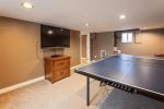 Fun game room downstairs with a full size Ping Pong table, TV and extra sleeping space