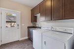 The laundry room is right off the kitchen & back entrance. There are beach towels to use for the hot tub and the nearby beach`s. There are beach toys as well 