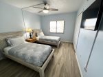 Guest Bedroom with Two Twin Beds and Flat Screen TV