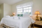 The upstairs guest bedroom invites you to a queen bed with sweeping south views of the property.  Relax in a calm space that provides fresh simplicity. 